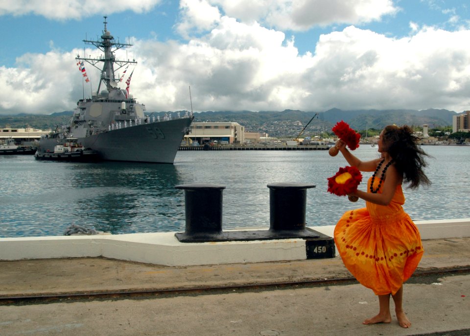 US Navy 060905-N-4965F-003 A Polynesian dancer welcomes home Sailors from the guided missile destroyer USS Russell (DDG 59) after returning from a six-month deployment