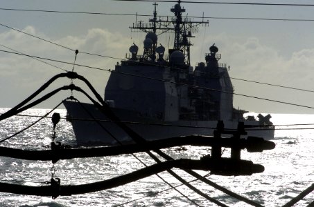 US Navy 060901-N-8604L-071 The guided-missile cruiser USS Cowpens (CG 63) navigates alongside the Military Sealift Command fleet replenishment oiler USNS Tippecanoe (T-AO 199)