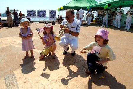 US Navy 060903-N-6501M-014 Navy Musician 1st Class Brian Grondell plays a trumpet solo and encourages some audience participation photo