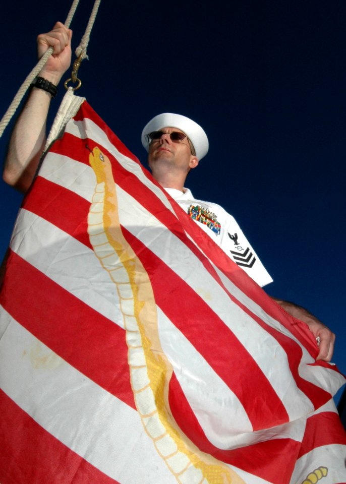 US Navy 060831-N-4965F-002 Operations Specialist 1st Class Stephen Cornell, an anti-submarine tactical controller stationed on board USS Rueben James (FFG 57) homeported in Pearl Harbor, Hawaii, prepares to raise the Navy Jack