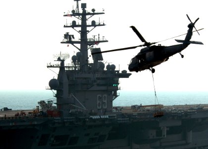 US Navy 060907-N-0490C-012 An MH-60S Seahawk helicopter, assigned to the Dragon Whalers of Helicopter Sea Combat Squadron Two Eight (HSC-28), transfers ordnance to the flight deck of the Nimitz-class aircraft carrier USS Dwight