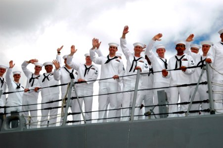 US Navy 060905-N-4965F-007 Sailors assigned to guided missile destroyer USS Russell (DDG 59) wave to friends and family members as the ship returns following a six-month deployment