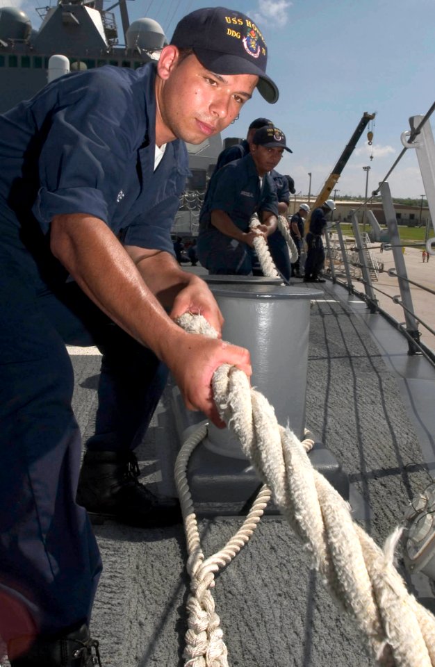US Navy 060903-N-9851B-001 Seaman Edward Castoire heaves in a mooring line as the Arleigh Burke-class guided missile destroyer USS Hopper (DDG 70) moors in Guam for a port visit