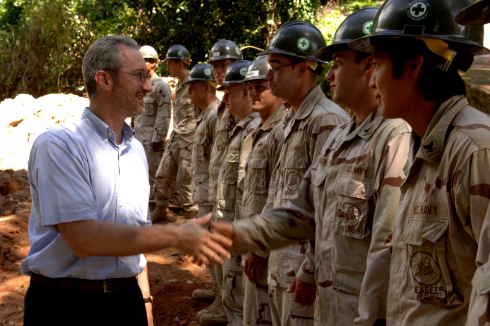 US Navy 061011-F-0929W-002 Charge D' Affaires Stephen Schwartz of the U.S. Embassy Port Louis, Mauritius, shakes hands with Navy Seabees prior to a groundbreaking ceremony for a new Baie St. Anne Hospital mortuary on Pras