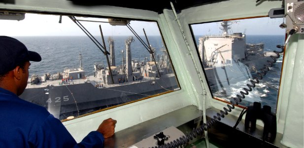 US Navy 060904-N-4856C-060 Ensign Danny L. Dorsey from Woodbridge, Va. observes a replenishment at sea (RAS) between the Japanese supply ship Mashu (AOE 425) and USS Iwo Jima (LHD 7)
