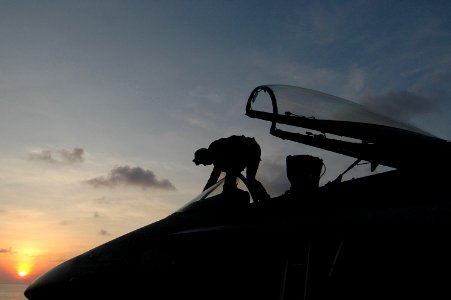 US Navy 060909-N-8604L-179 Airman Kenneth Downs cleans the canopy of an F-A-18C Hornet assigned to Strike Fighter Squadron One Nine Two (VFA-192) on the flight deck of USS Kitty Hawk (CV 63)