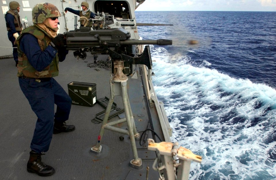 US Navy 060906-N-9851B-002 Gunner's Mate 2nd Class Justin Shea fires a Mark-19 40mm grenade launcher from the weather deck aboard the Arleigh Burke-class guided missile destroyer USS Hopper (DDG 70) during a familiarization fir