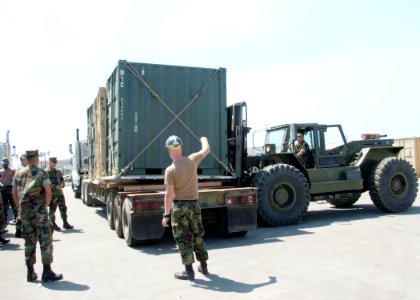 US Navy 060831-N-3560G-040 Members of Naval Mobile Construction Battalion Four (NMCB-4) prepare to transport Tricon Containers photo