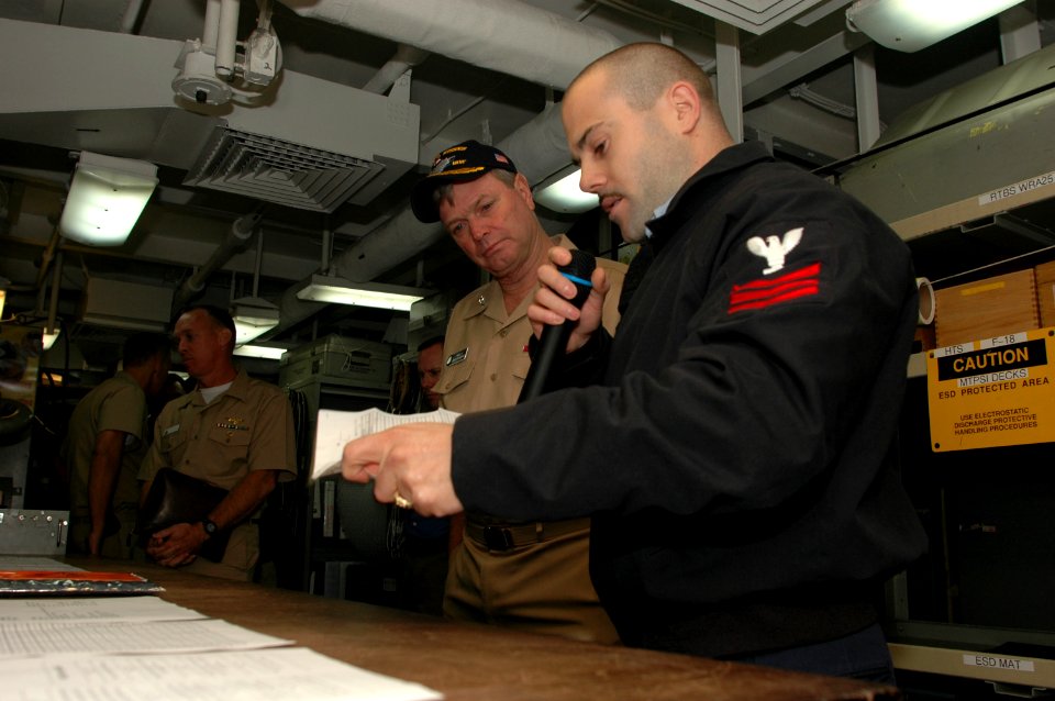 US Navy 060906-N-2659P-125 Aviation Electronics Technician 1st Class Chad Hutchens talks with Vice Adm. Walter Massenburg during the admiral's visit to the Nimitz-class aircraft carrier USS John C. Stennis (CVN 74)