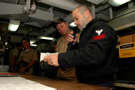 US Navy 060906-N-2659P-125 Aviation Electronics Technician 1st Class Chad Hutchens talks with Vice Adm. Walter Massenburg during the admiral's visit to the Nimitz-class aircraft carrier USS John C. Stennis (CVN 74)