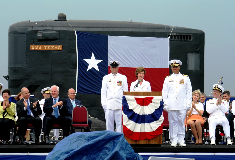 US Navy 060909-N-0653J-005 Accompanied by Command Master Chief Mark Brooks, center-left, and Commanding Officer John J. Litherland, center-right, First Lady Laura Bush, delivers her remarks