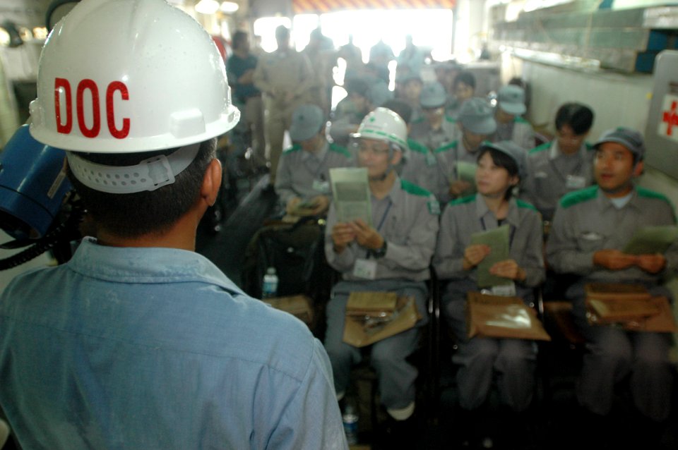 US Navy 060901-N-1332Y-353 Hospital Corpsman 1st Class Juan Brebonerta supervises as Tokyo Metropolitan Government employees are instructed on how to prepare a meal-ready-to-eat (MRE), during a disaster drill
