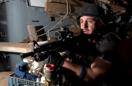 US Navy 060909-N-9851B-004 Fire Controlman 1st Class Anthony Rosa assigned to the guided missile destroyer USS Hopper (DDG 70) visit, board, search and seizure team holds a position during a noncompliant boarding exercise photo