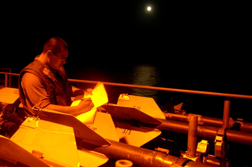 US Navy 060908-N-8604L-765 Aviation Ordnanceman Airman Antonio Villarreal inventories CATM-9M missiles on the flight deck of USS Kitty Hawk (CV 63)