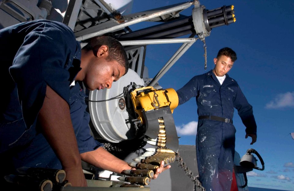 US Navy 060902-N-9851B-004 Fire Controlman 3rd Class Haneef Manboard and Fire Controlman 3rd Class Joseph Jaramillo download ammunition from a Close-In Weapons System