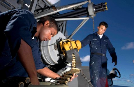 US Navy 060902-N-9851B-004 Fire Controlman 3rd Class Haneef Manboard and Fire Controlman 3rd Class Joseph Jaramillo download ammunition from a Close-In Weapons System photo