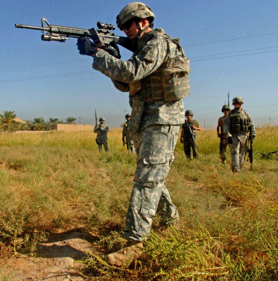 US Navy 060915-N-4097B-007 U.S. Army Spc. Tyler Crubaudh, with Alpha Company, 1st Battalion, 68th Armored Regiment, 3rd Heavy Brigade Combat Team, 4th Infantry Division, demonstrates marksmanship skills to Iraqi army soldiers