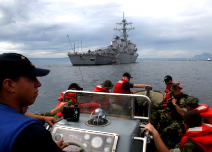 US Navy 061023-N-4953E-012 Boatswain's Mate 3rd Class Robert Barrios performs duties as Coxwain (under instruction) while taking a visit, board, search, and seizure team assigned to guided-missile destroyer USS Stethem (DDG 63) photo