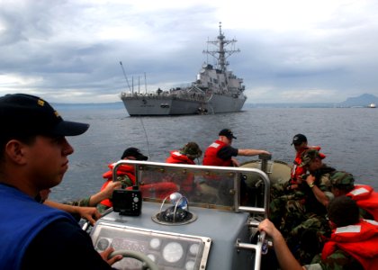 US Navy 061023-N-4953E-012 Boatswain's Mate 3rd Class Robert Barrios performs duties as Coxwain (under instruction) while taking a visit, board, search, and seizure team assigned to guided-missile destroyer USS Stethem (DDG 63)