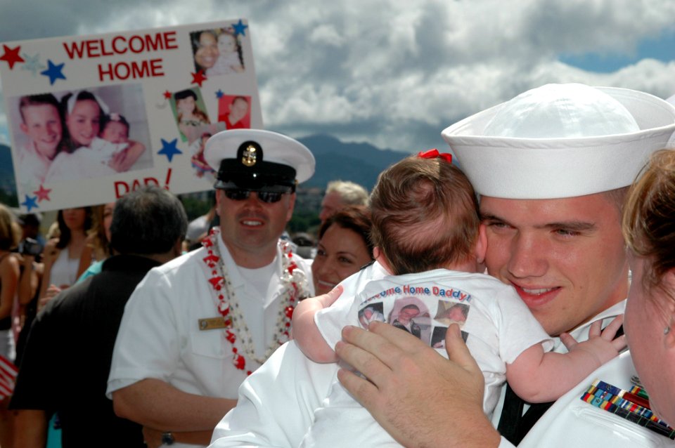 US Navy 060905-N-4965F-009 Sailors assigned to guided missile destroyer USS Russell (DDG 59) re-unite with friends and family members after returning from a six-month deployment