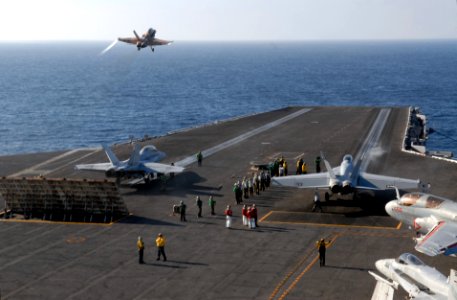 US Navy 061023-N-4776G-107 The flight deck of USS Ronald Reagan (CVN 76) is a bustle with F-A-18 Hornets taking off and landing during flight operations