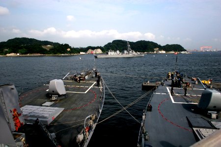 US Navy 061015-N-4953E-002 Boatswain's mates on board guided-missile destroyers USS Stethem (DDG 63) (left) and USS Fitzgerald (DDG 62) prepare to take in lines as the Stethem prepares to get underway from her homeport in