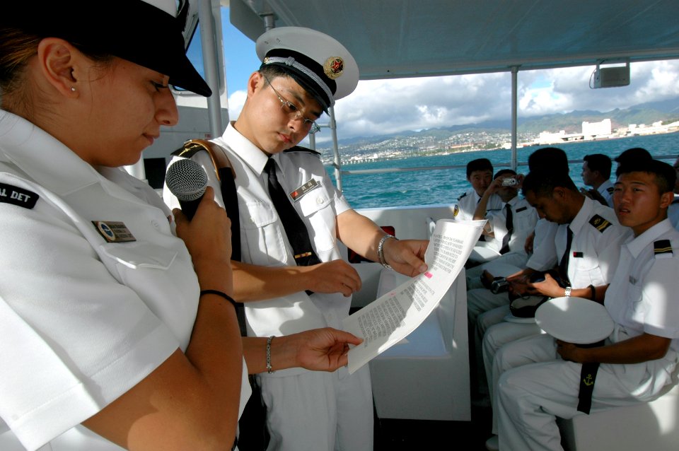 US Navy 060907-N-4965F-005 Seaman Adriana TiradoArreola assigned to USS Arizona Memorial Detachment white boat crew explains the history of the U.S. Navy at Pearl Harbor