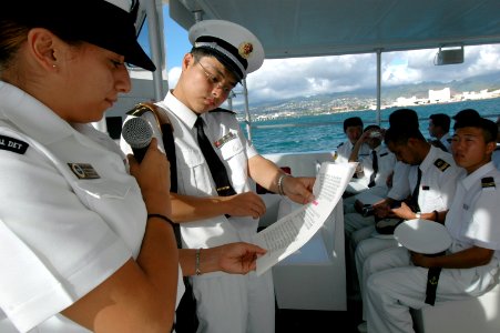 US Navy 060907-N-4965F-005 Seaman Adriana TiradoArreola assigned to USS Arizona Memorial Detachment white boat crew explains the history of the U.S. Navy at Pearl Harbor