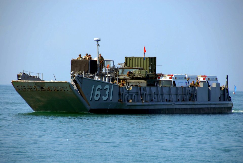 US Navy 061025-A-3465M-003 Landing Craft Utility 1631 approaches shore to deliver five of 14 ambulances donated to the Philippines by the 3P Foundation (USA)