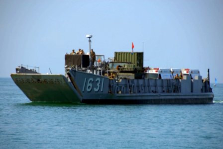 US Navy 061025-A-3465M-003 Landing Craft Utility 1631 approaches shore to deliver five of 14 ambulances donated to the Philippines by the 3P Foundation (USA)