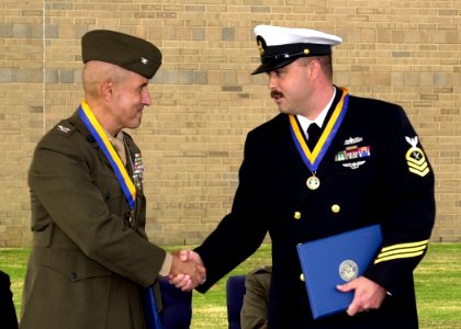 US Navy 061020-N-1082Z-003 Marine Corps Intelligence Training Center (NMITC) Executive Officer Col. Francis X. Cubillo congratulates Chief Intelligence Specialist Danny Leek after each were selected for the Rear Adm. Edwin T. L