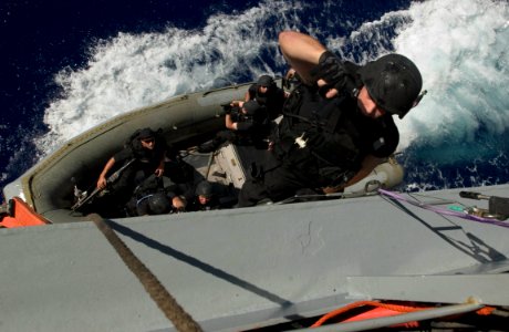 US Navy 060909-N-9851B-003 Gunner's Mate Jonathan Bashlor uses his 9mm side arm to clear the deck of the Military Sealift Command underway replenishment ship USNS John Ericsson (TAO-194) photo