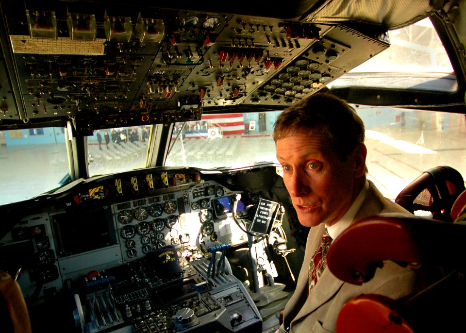 US Navy 061026-N-4515N-172 A guest at the vintage awards ceremony to honor the coast guardsmen that rescued Navy Sailors from a crash sits in the cockpit of a P-3 Orion