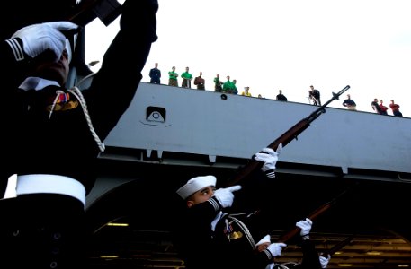 US Navy 061027-N-7130B-175 During a burial at sea on board USS Ronald Reagan (CVN 76), members of the ship's ceremonial guard render honors to the deceased via a 21-gun salute photo