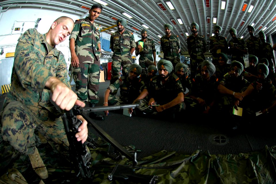 US Navy 061026-N-0209M-006 A Marine assigned to Weapons Company, Battalion Landing Team 2-4, attached to the 15th Marine Expeditionary Unit (Special Operations Capable) gives small arms training to Indian soldiers