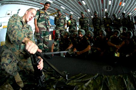 US Navy 061026-N-0209M-006 A Marine assigned to Weapons Company, Battalion Landing Team 2-4, attached to the 15th Marine Expeditionary Unit (Special Operations Capable) gives small arms training to Indian soldiers