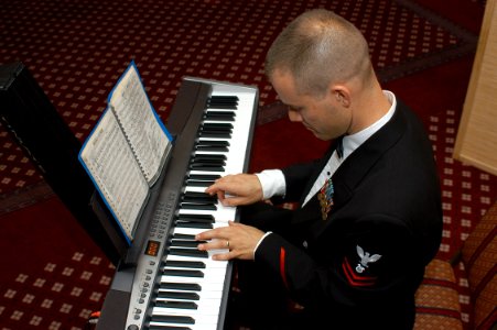 US Navy 061024-N-2716P-002 Musician 2nd Class Dirk Denton, assigned to the 7th Fleet Navy Band, plays the keyboard during the Executive Forum Dinner held at the Officer's Club of Commander Fleet Activities Yokosuka