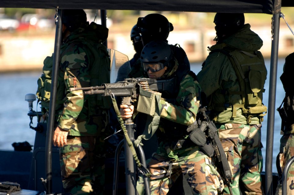 US Navy 061023-N-5319A-095 An Iraqi Solider assigned to Iraqi Riverine Police Force mans a M-60 machine gun during special boat maneuvers and weapon handling training