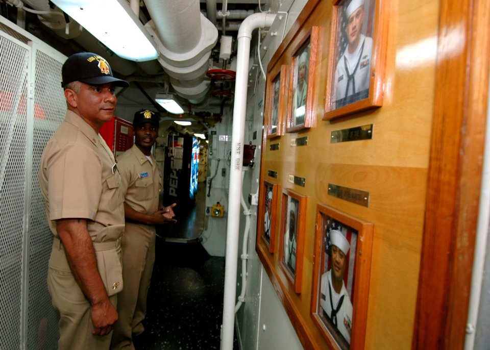 US Navy 061030-N-4965F-001 Master Chief Petty Officer of the Navy (MCPON) Joe R. Campa Jr. views a photo roster board of Sailors assigned to the Ticonderoga-class guided missile cruiser USS Lake Erie (CG 70) during a visit to N