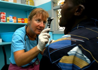 US Navy 060916-N-1328C-276 United States Army Capt. Gwynne Kinley, assigned to the 96th Civil Affairs Battalion from Hilton Head, S.C., exams patients during a Medical Civic Action Program (MEDCAP) visit to Hindi, Kenya photo