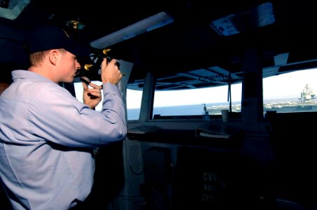 US Navy 061031-N-5330L-160 Quartermaster Seaman Richard Armstrong, a Sailor on board the Nimitz-class aircraft carrier USS Dwight D. Eisenhower (CVN 69), uses a sextant on the bridge aboard the Enterprise-class aircraft carrier
