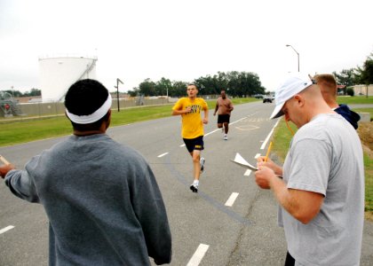 US Navy 061102-N-7427G-002 Yeoman 3rd Class Timothy Seidel sprints toward the finish line during the Physical Fitness Assessment (PFA) held aboard Naval Air Station Joint Reserve Base New Orleans