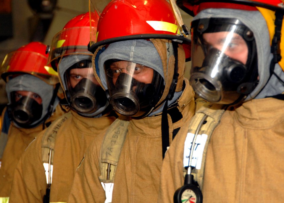 US Navy 061026-N-8923M-013 Sailors dress out in full firefighting equipment while participating in a general quarters (GQ) drill on board USS Harry S. Truman (CVN 75)