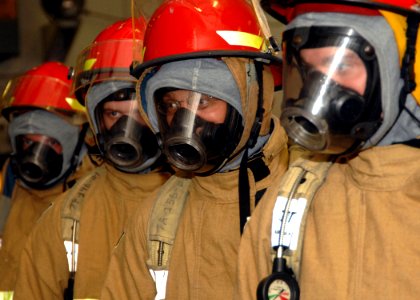 US Navy 061026-N-8923M-013 Sailors dress out in full firefighting equipment while participating in a general quarters (GQ) drill on board USS Harry S. Truman (CVN 75)