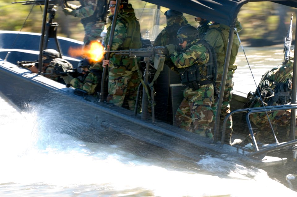US Navy 061023-N-5319A-108 An Iraqi Soldier assigned to Iraqi Riverine Police Force fires a M-60 machine gun during special boat maneuvers and weapon handling training at Stennis Space Center