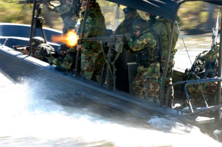 US Navy 061023-N-5319A-108 An Iraqi Soldier assigned to Iraqi Riverine Police Force fires a M-60 machine gun during special boat maneuvers and weapon handling training at Stennis Space Center
