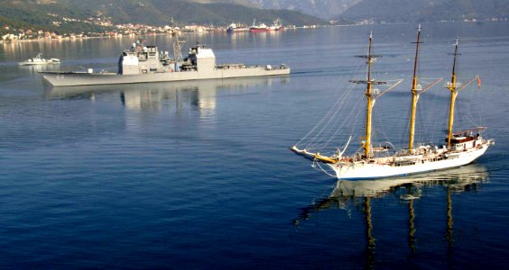 US Navy 061026-N-5330L-271 The Montenegrin ship Jadron sails alongside the guided missile cruiser USS Anzio (CG 68) as the ship departs Tivat, Montenegro following a three-day visit to strengthen the relationship between the tw
