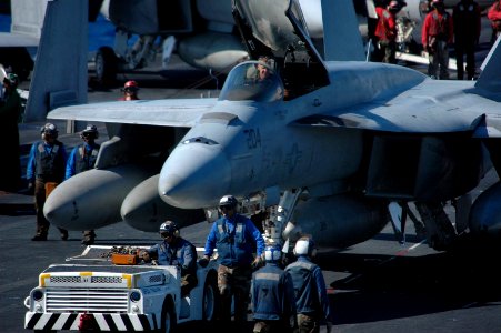 US Navy 061027-N-6106R-003 Flight deck Sailors tow an F-A-18E Super Hornet across the flight deck of USS Kitty Hawk (CV 63) prior to cyclic flight operations