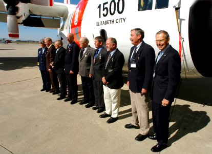 US Navy 061026-N-4515N-185 Crew Six of a HC-130H Hercules class aircraft, Coast Guard 1500 (CG 1500), stand in front of their old plane during a vintage award ceremony