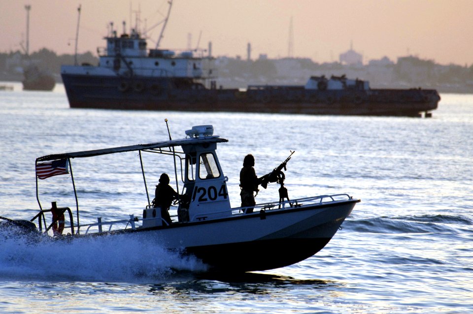 US Navy 061030-N-8148A-072 U.S. Navy Sailors Assigned to the harbor patrol boat unit from Naval Security Force Bahrain, monitor merchant ship traffic off the coast